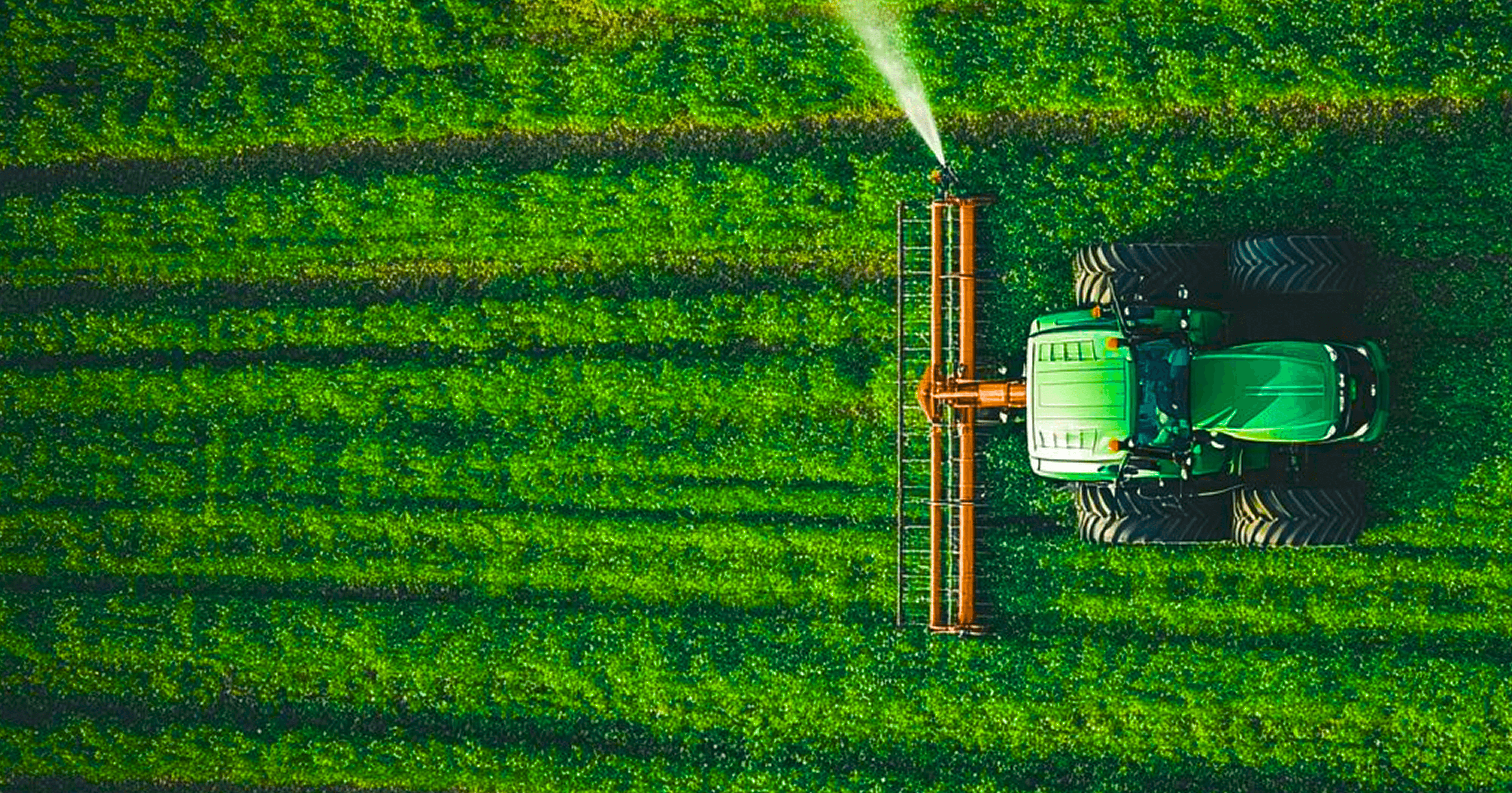 Aerial view of tractor working in a green field
